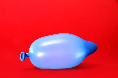 a blue balloon on a red backgroundの写真素材