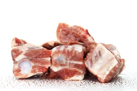 a few pork ribs with drops on a white backgroundの写真素材