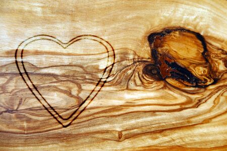 heart carved on an old woodの写真素材
