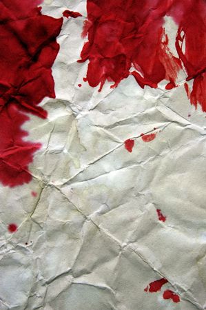 background made with blood-stained crumpled paperの写真素材