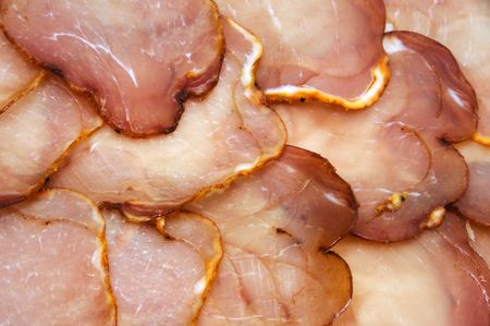 some slices of cured pork loin over a boardの写真素材