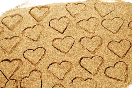 hearts drawn on the sand の写真素材