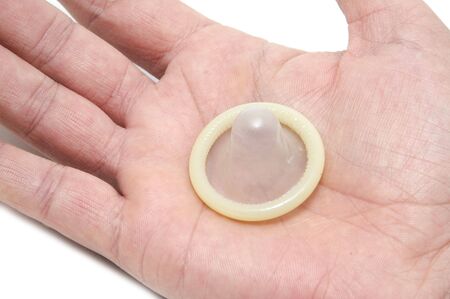 giving a  condom on a white backgroundの写真素材
