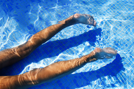 someone swimming on a pool in the summer
