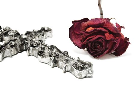 emo rose and a baroque cross on a white backgroundの写真素材