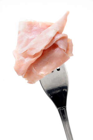slice of ham on a fork isolated on the white backgroundの写真素材