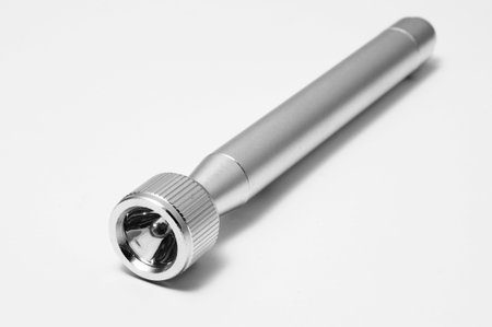 a chrome flashlight isolated on a white background