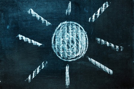 a sun drawn with a chalk on a blackboardの写真素材