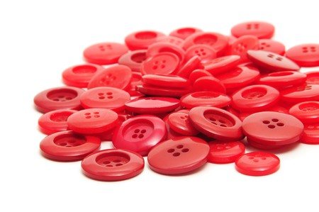 a pile of red buttons isolated on a white backgroundの写真素材