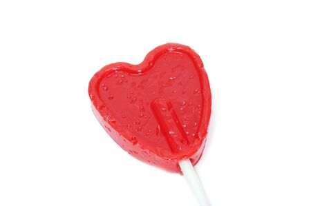a heart-shapped lollipop on a white backgroundの写真素材