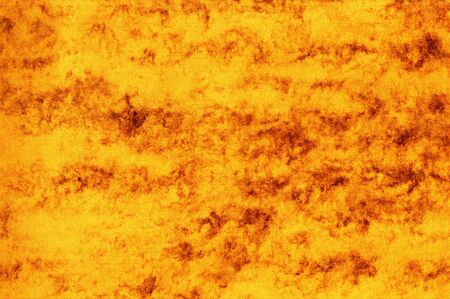 grunge background made of a closeup of a ocher textureの写真素材