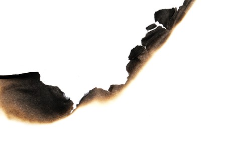 burned paper isolated on a white backgroundの写真素材