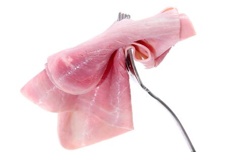 slice of ham on a fork isolated on a white backgroundの写真素材