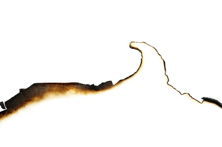 burned paper isolated on a white backgroundの写真素材