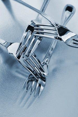 closeup of some silver forks in black and white