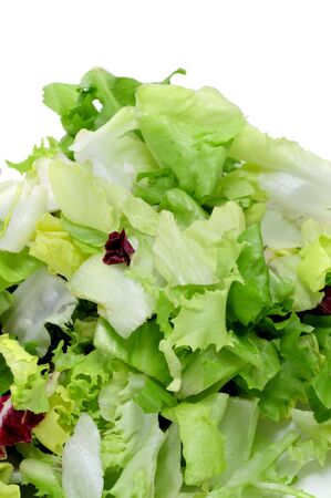closeup of a pile of lettuce mix isolated on a white backgroundの写真素材