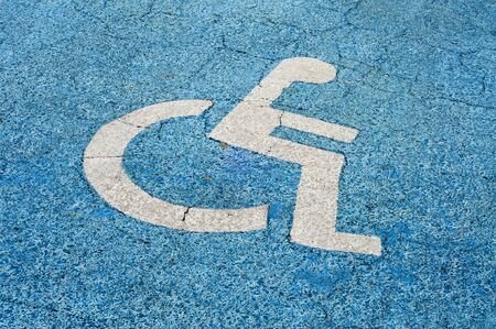 Disabled parking permit sign painted on the streetの写真素材