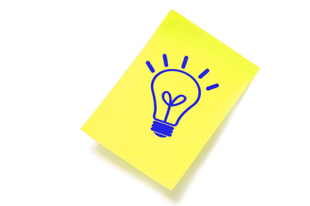 a light bulb drawn in a sticky note symbolizing concept idea