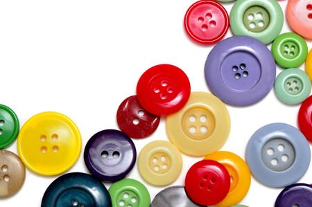 buttons of many colors on a white backgroundの写真素材