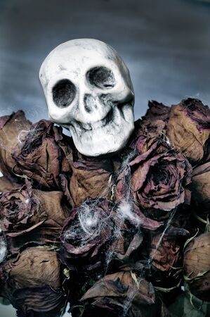 closeup of a dried roses bouquet with a skull for Halloweenの写真素材