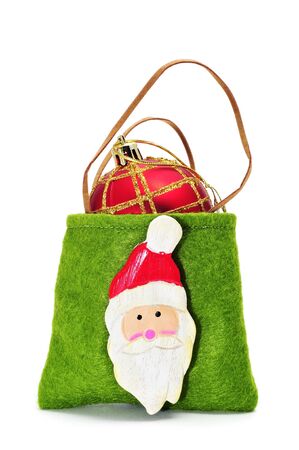 a christmas ball inside a Santa Claus bag on a white background の写真素材