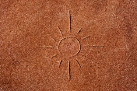 a sun carved on a red stoneの写真素材