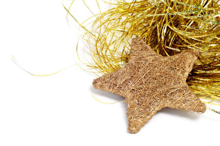 a golden christmas star and golden tinsel on a white background の写真素材