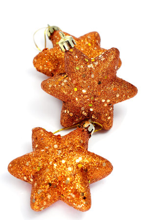 some golden christmas stars on a white background 