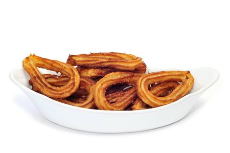 churros on a white background, typical Spanish sweetの写真素材