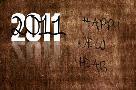 happy new year 2011 written in a brown textured backgroundの写真素材