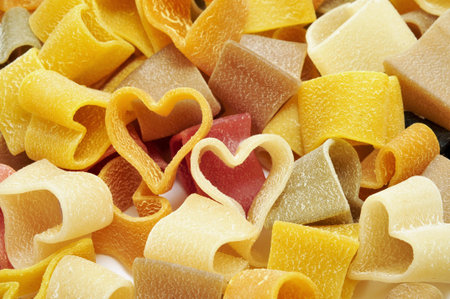 a pile of uncooked vegetables heart shaped pastaの写真素材