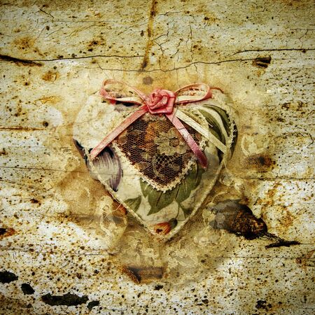 a vintage fabric heart on a grunge backgroundの写真素材