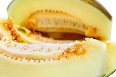 closeup of some slices of melon on a white background
