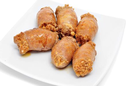 some red fried spanish chorizos on a white backgroundの写真素材