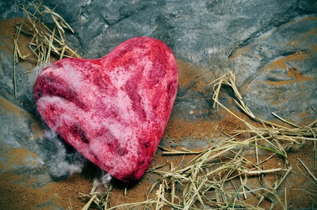 red heart in a gray rock backgroundの写真素材