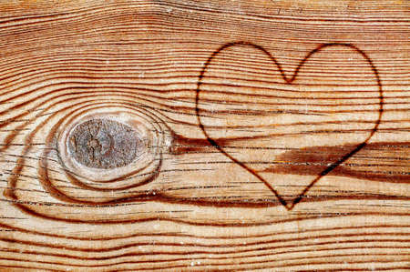 a heart burned in an old wood boardの写真素材