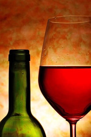 closeup of a bottle and a glass with red wineの写真素材