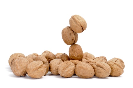 a pile of walnuts isolated on a white backgroundの写真素材