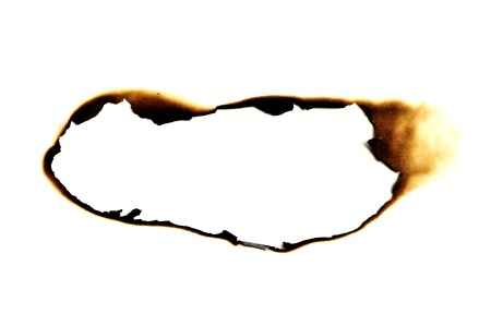 burned hole on a white paper backgroundの写真素材