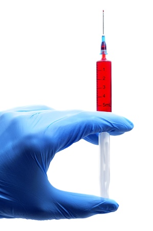 someone wearing medical gloves holding a syringe with bloodの写真素材