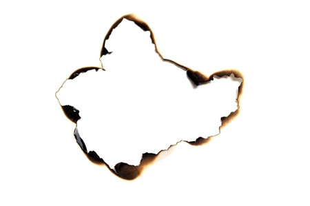 burned hole on a white paper background