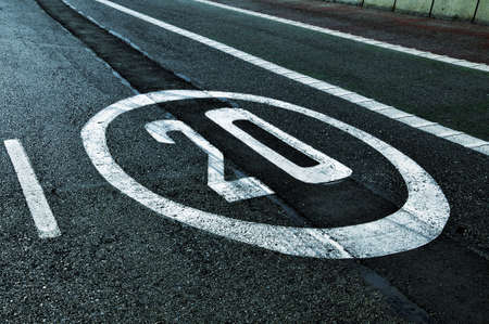 a speed limit sign painted on the roadの写真素材