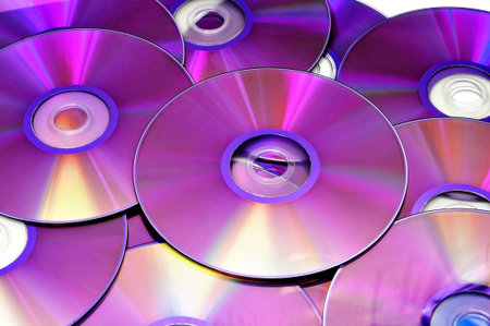 closeup of a pile of CD, CD-ROM and DVD