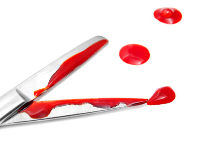 closeup of a bloody scissors on a white background