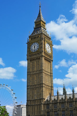 London, United Kingdom - May 9, 2011: Big Ben with the London Eye in the background in London, United Kingdom. London Eye is the tallest Ferris wheel in Europe at 135 metersのeditorial素材