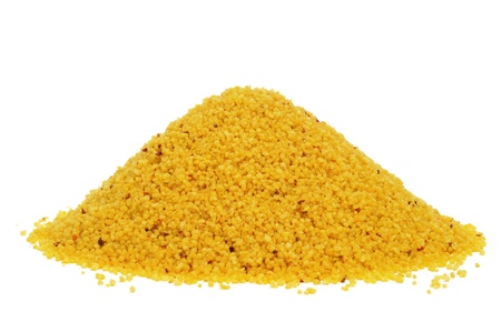 a pile of uncooked spiced couscous on a white backgroundの写真素材