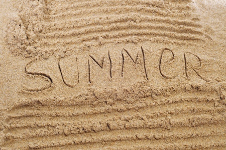 word summer written in the sand of a beachの写真素材