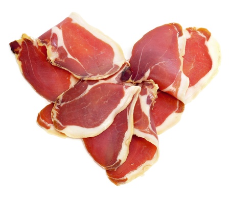 a pile of spanish serrano ham forming a heartの写真素材