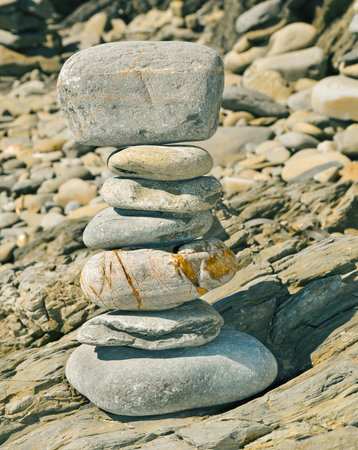 a strack of zen stones on a shingle beach