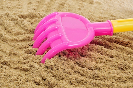 closeup of a beach rake on the sandの写真素材